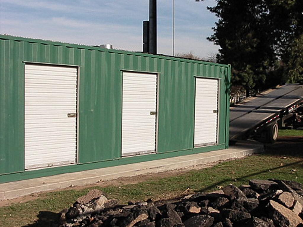 Modified shipping container with three i
ndividual roll-up doors.