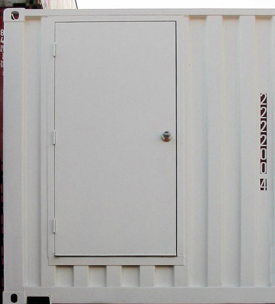 Modified shipping container with a personal door installed