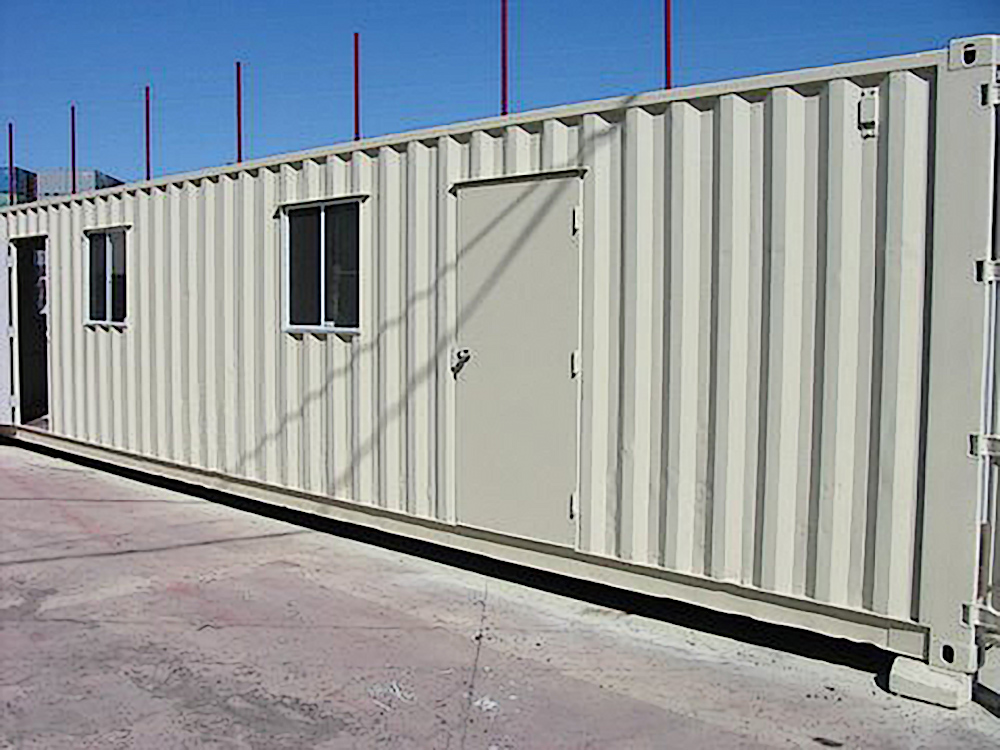 Modified shipping container with sliding windows and a personal door installed